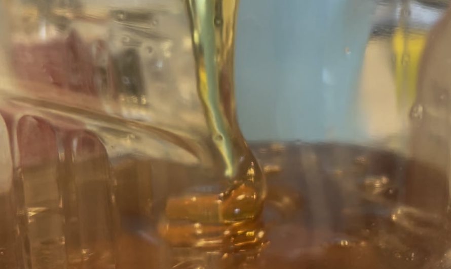 Honey flowing out of funnel