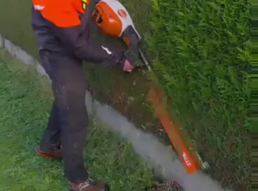 Precision machinery at work creating a perfectly trimmed hedge
