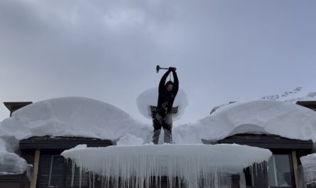 Removing ice from a Canadian roof.