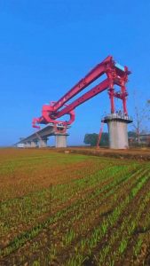 This is a bridge girder machine which is used by construction crews to individually place blocks of concrete during the development process