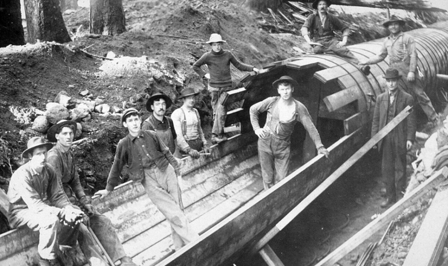 Using wood pipelines to transport water, at the turn of the century. Some older examples were holed out tree trunks. Photos circa 1900s-20s