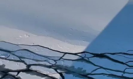 Waves caused by the ship's movement break the ice layer