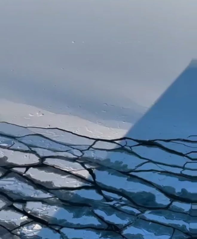 Waves caused by the ship's movement break the ice layer
