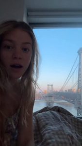 Young lady captures a full moon over the Williamsburg bridge