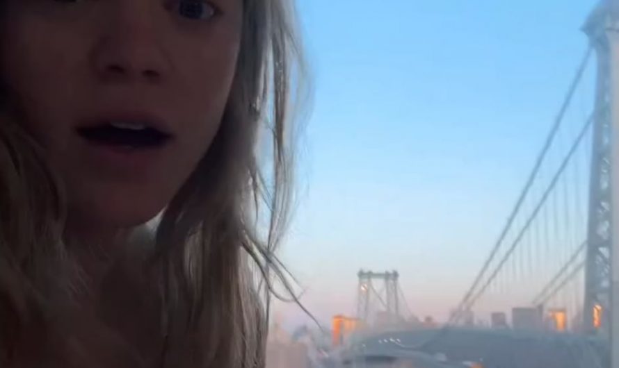 Young lady captures a full moon over the Williamsburg bridge