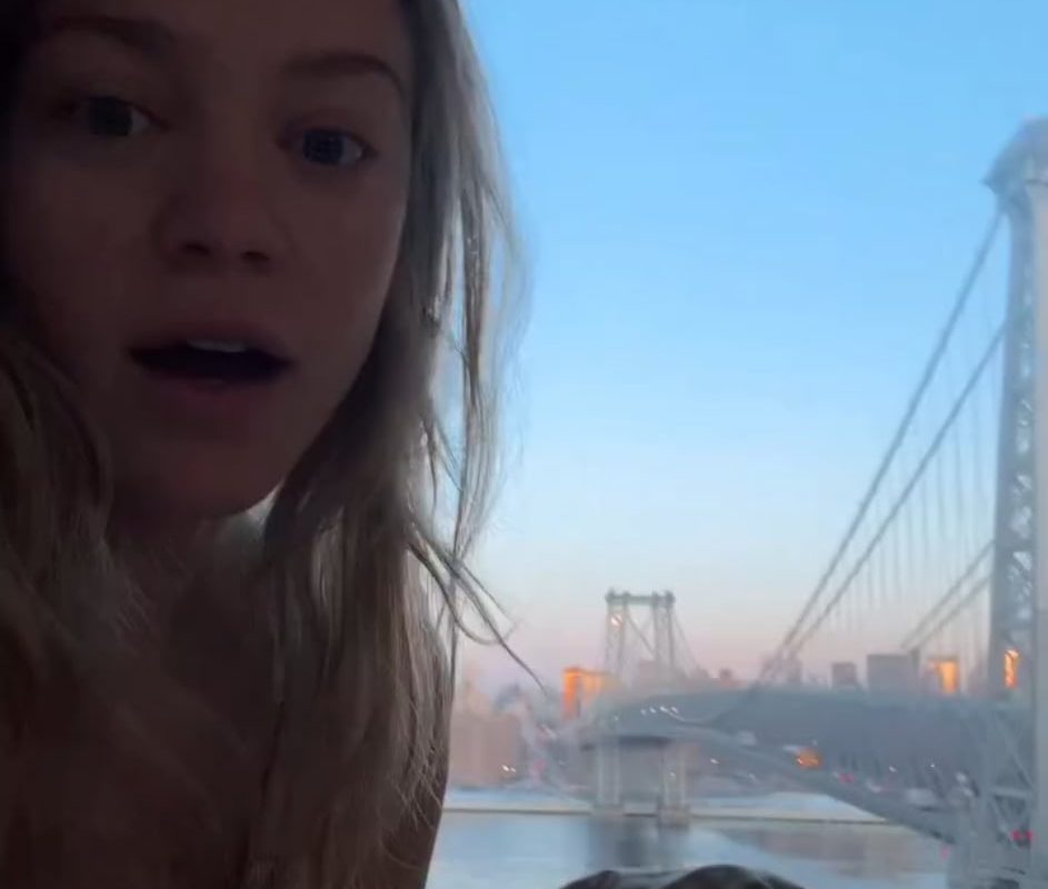 Young lady captures a full moon over the Williamsburg bridge