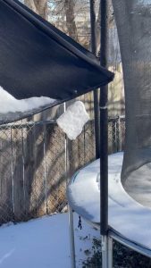 a sheet of snow spinning by a thread on my outdoor umbrella