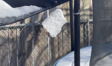 a sheet of snow spinning by a thread on my outdoor umbrella