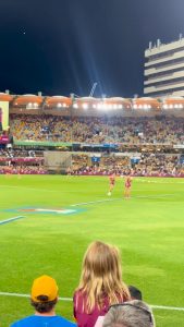 A kid runs on the field at an Australian Rules Football game and security cannot catch him
