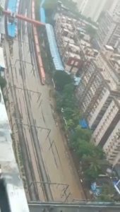 A train plowing through the flooded tracks