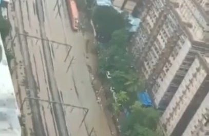 A train plowing through the flooded tracks