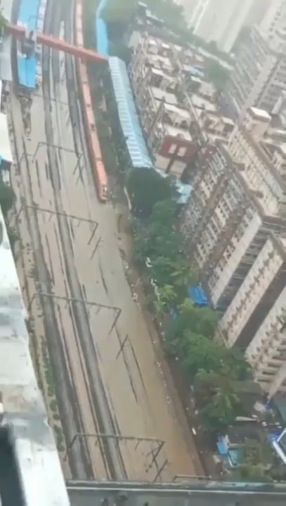 A train plowing through the flooded tracks