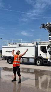 Apron crew at Zurich airport cooling off with a deicing shower