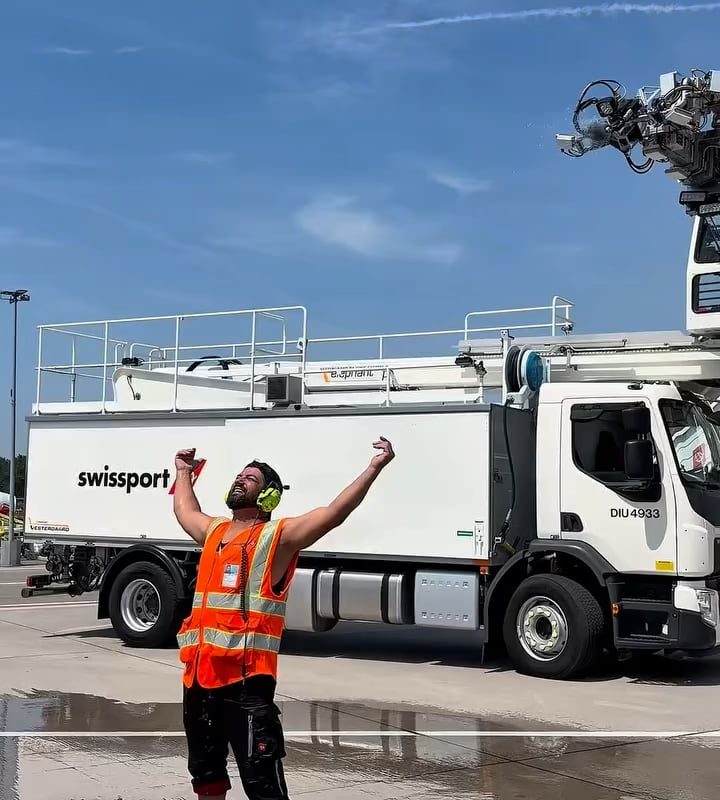 Apron crew at Zurich airport cooling off with a deicing shower