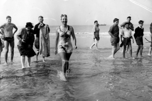 Champion swimmer Florence Chadwick comes out of the water and becomes the fastest time crossing the english channel at 13hr and 23min. 8 of August 1950.