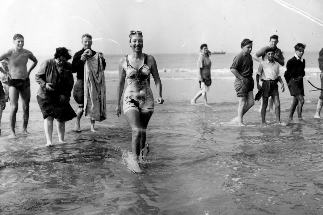 Champion swimmer Florence Chadwick comes out of the water and becomes the fastest time crossing the english channel at 13hr and 23min. 8 of August 1950.