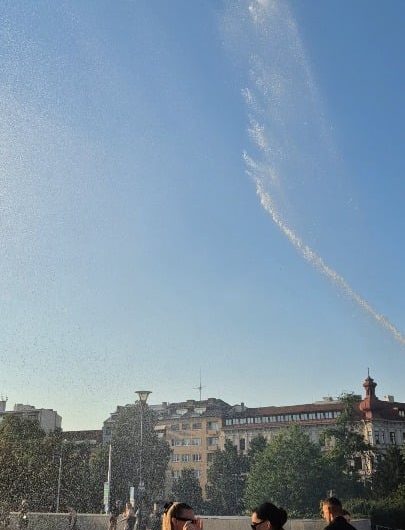 Czech firemen cooling down people at an outdoor event in Brno