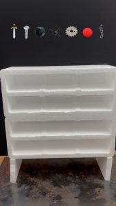 Dropping red hot metal shapes through a polystyrene foam shelf