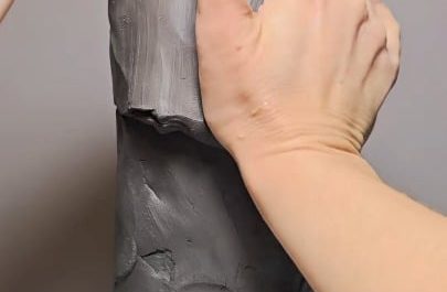 Hand-sculpting a detailed Native American chief from a rough mound of clay