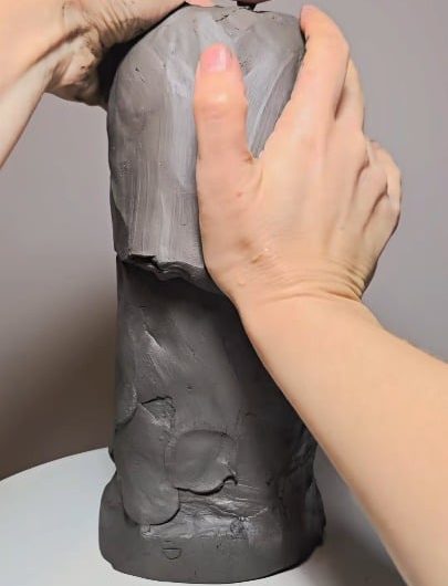 Hand-sculpting a detailed Native American chief from a rough mound of clay