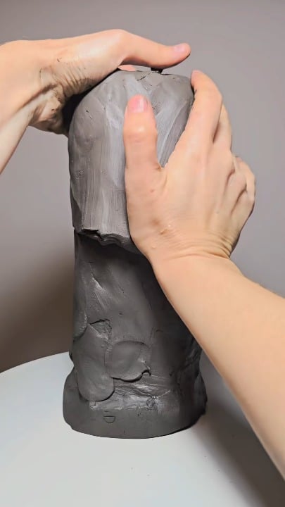 Hand-sculpting a detailed Native American chief from a rough mound of clay