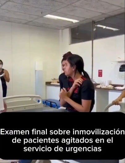 Healthcare workers participating in a medical simulation for an agitated patient scenario.