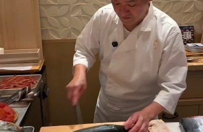 Japanese chef preparing Saba (mackarel) attentively before the next step