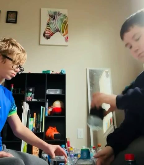 Kids pull off an impressive 5 bottle flip stack.