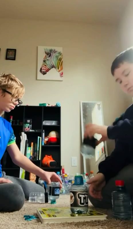 Kids pull off an impressive 5 bottle flip stack.