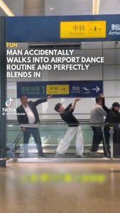 Man blends into the Xiluodo Art Troupe as they perform The Dunhuang Flying apsaras dance routine in Hongqiao Airport, Shanghai, China