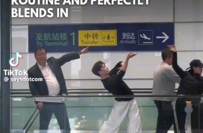 Man blends into the Xiluodo Art Troupe as they perform The Dunhuang Flying apsaras dance routine in Hongqiao Airport, Shanghai, China