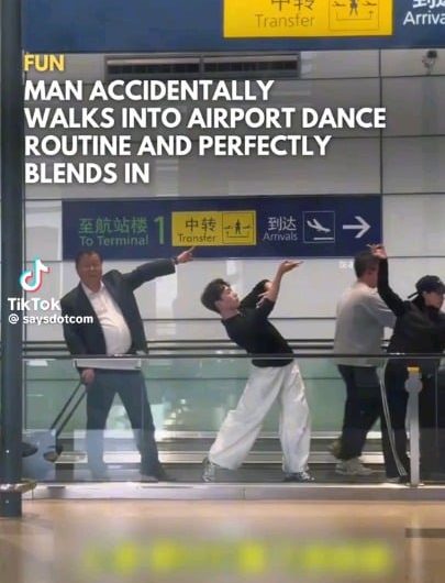 Man blends into the Xiluodo Art Troupe as they perform The Dunhuang Flying apsaras dance routine in Hongqiao Airport, Shanghai, China