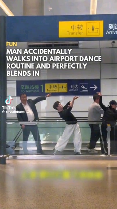 Man blends into the Xiluodo Art Troupe as they perform The Dunhuang Flying apsaras dance routine in Hongqiao Airport, Shanghai, China