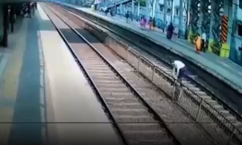 Man losses his shoe while crossing a railway track , goes back to pick up the shoes while the train is dangerously close gets slapped by the officer at the end