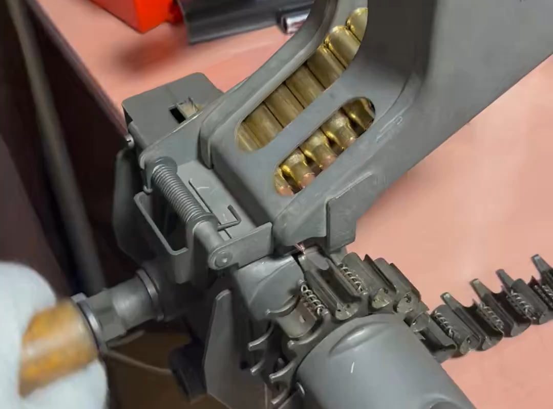 Mechanical reloading of bullets in the ammo belt