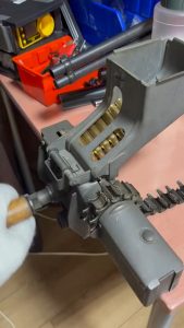Mechanical reloading of bullets in the ammo belt