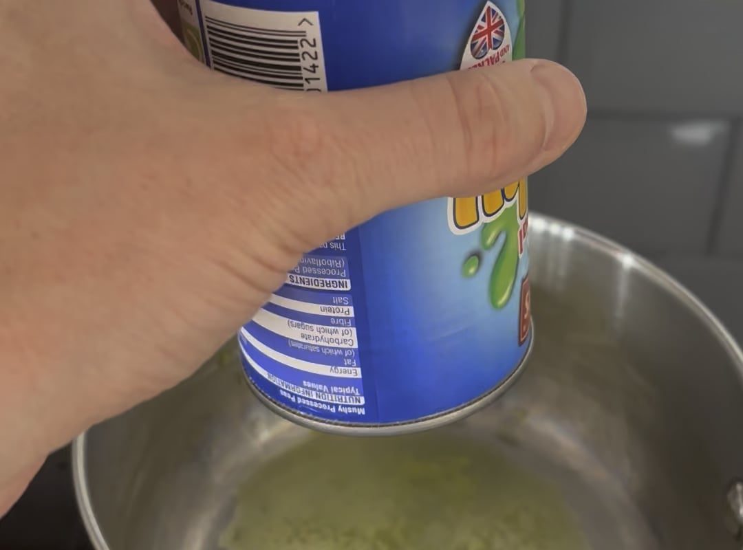 Mushy peas coming out of a tin