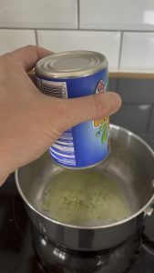 Mushy peas coming out of a tin
