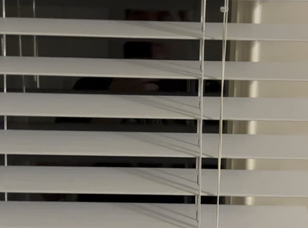 Pulling down the blind slates one-by-one