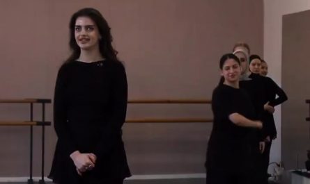 She is guessing the dance moves just by hearing the foot stamps
