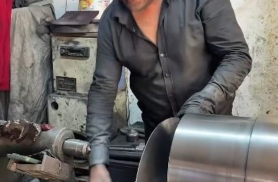 Spinning a flat aluminum disc into a deep pot on a lathe