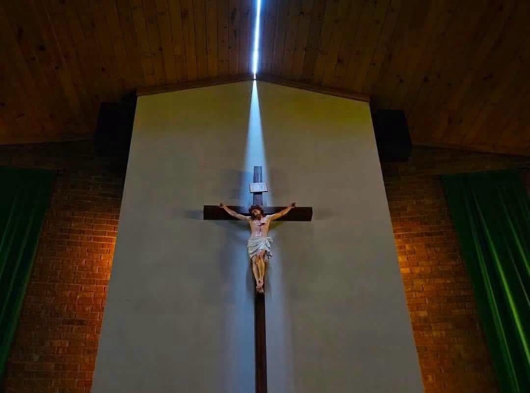 Storms with 131 MPH winds that went through Highmore, SD split the roof of St Mary's Catholic Church, which allowed sunlight to highlight the church's crucifix (Photo by Joseph Mat)