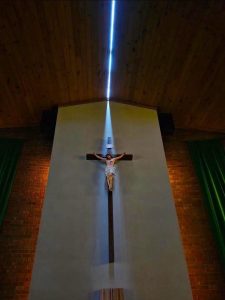 Storms with 131 MPH winds that went through Highmore, SD split the roof of St Mary's Catholic Church, which allowed sunlight to highlight the church's crucifix (Photo by Joseph Mat)