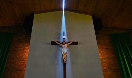 Storms with 131 MPH winds that went through Highmore, SD split the roof of St Mary's Catholic Church, which allowed sunlight to highlight the church's crucifix (Photo by Joseph Mat)