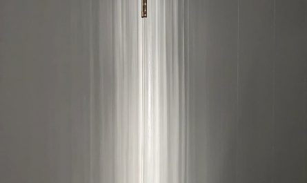 Sunset reflections off a lake through barely opened drapes
