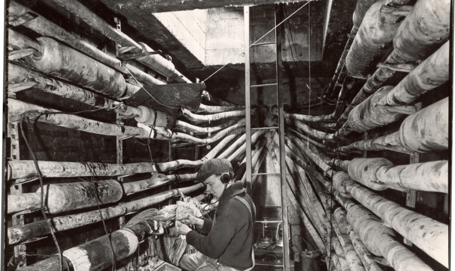 Telephone repair man working to find the problem in the network of cables under New York city, 1939.