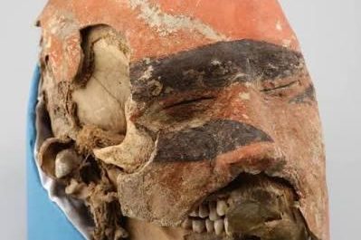 The funeral mask overlaying the face & skull of a warrior who lived 1700 years ago. He belonged to the Tashtyk culture and died after sustaining serious combat injuries.