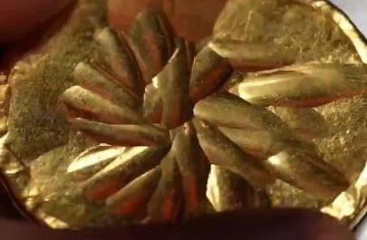 The precise process of hammering, hand-engraving, and detailing a gold cup