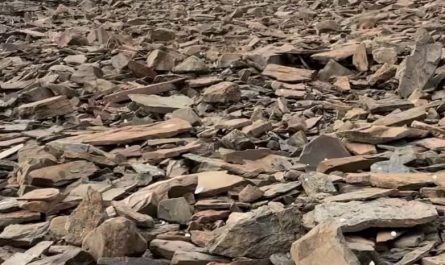 The sound of hail falling on a mountainside covered in slate rock