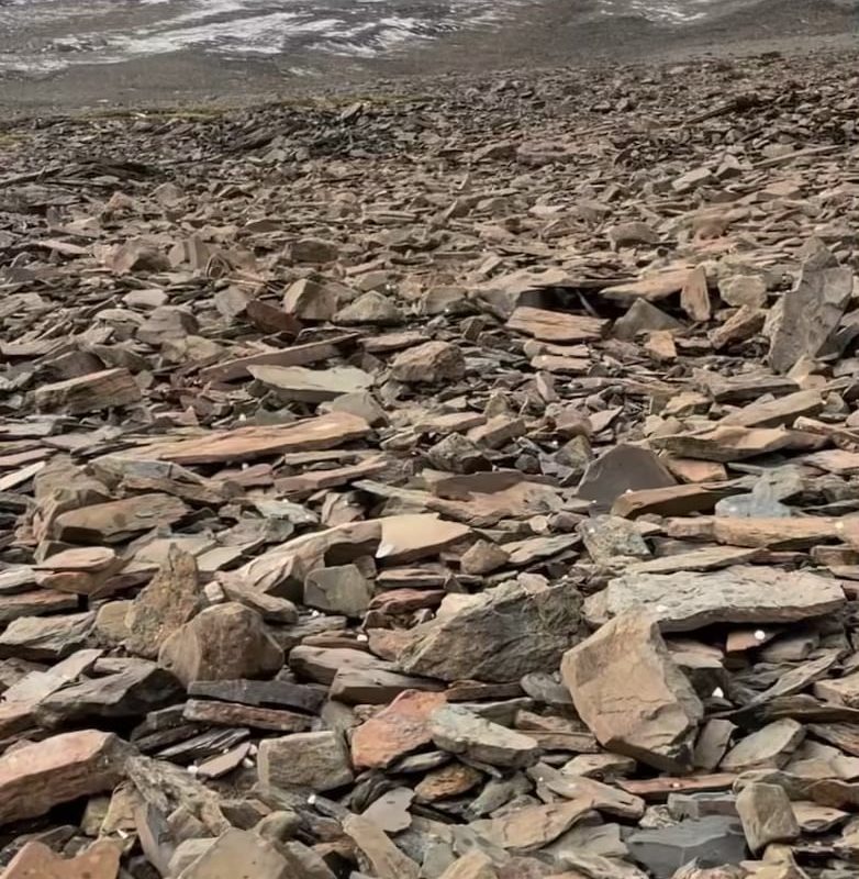 The sound of hail falling on a mountainside covered in slate rock